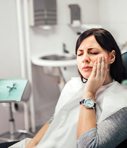 a patient experiencing tooth pain and needing implant salvage treatment