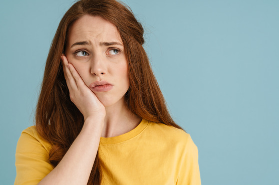 woman experiencing dental implant failure 